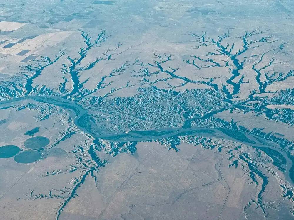 Vista aérea de un río dividiéndose en varios canales como metáfora de los flujos de debugging en entornos multimodelo